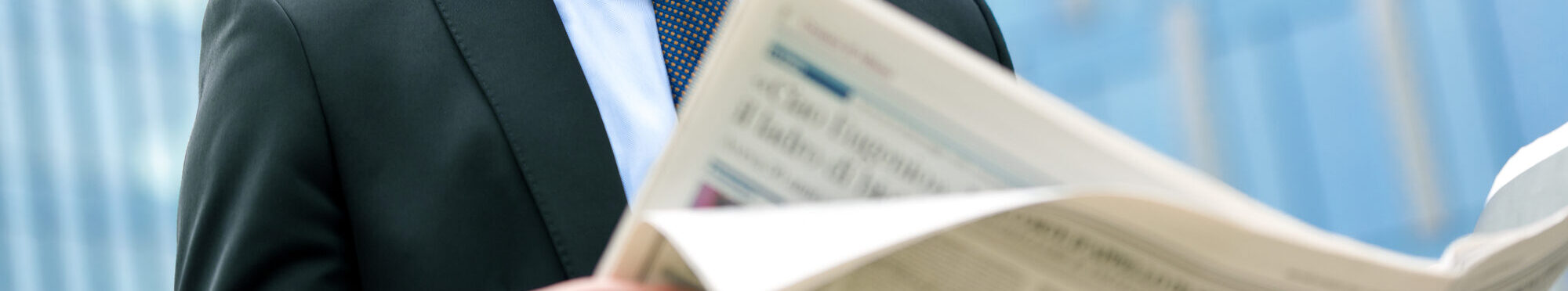 Young businessman reading a newspaper
