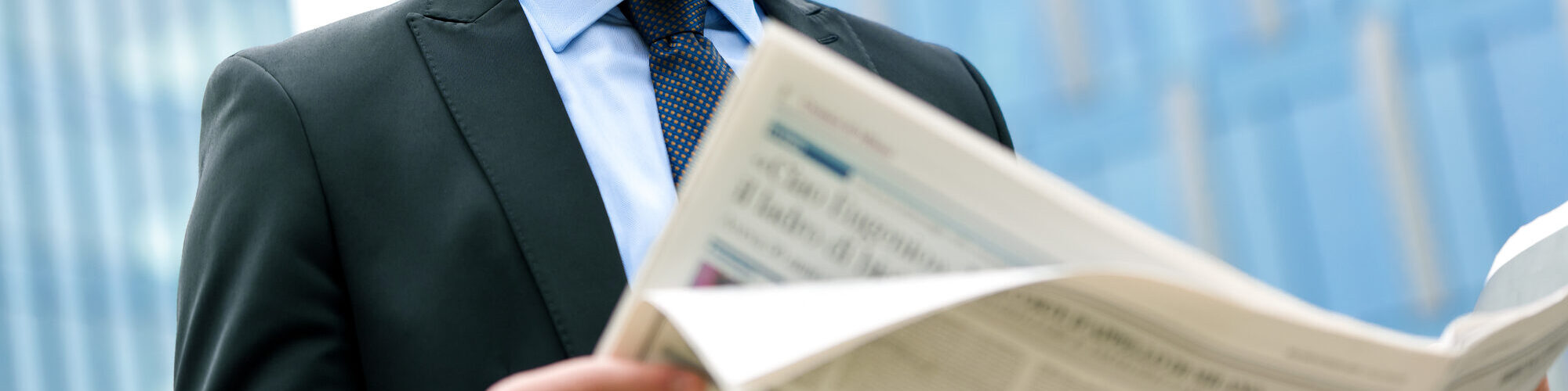 Young businessman reading a newspaper